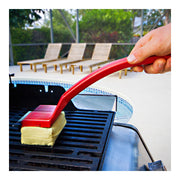 Unbranded bristle-free grill brush cleaning an outdoor grill