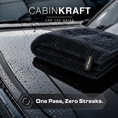 Drying towel absorbing water sheet off wet car hood